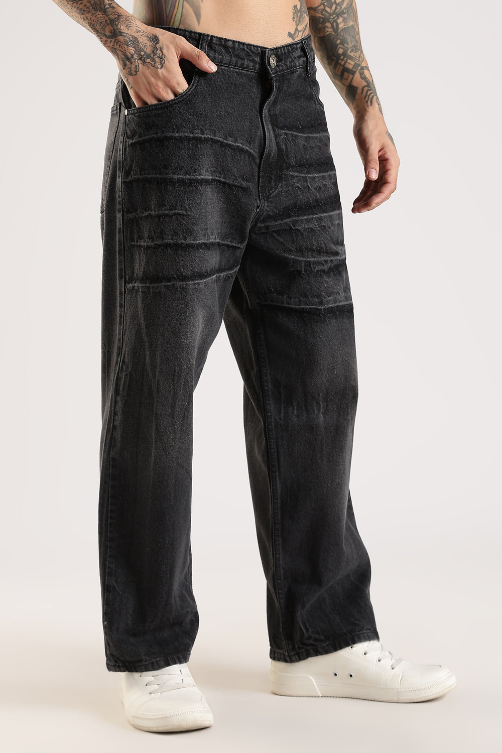 Person wearing black cargo pants on a white background